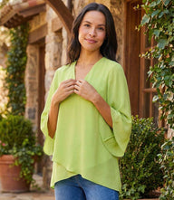 Bracelet Sleeve Asymmetric Top in silky crepe with v-neck, flare sleeves, and layered asymmetrical hem