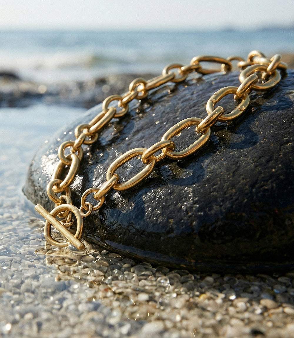 Handmade gold chain necklace with interlocking links and toggle clasp by Kenyan artisans