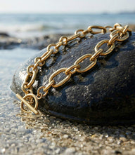 Handmade gold chain necklace with interlocking links and toggle clasp by Kenyan artisans