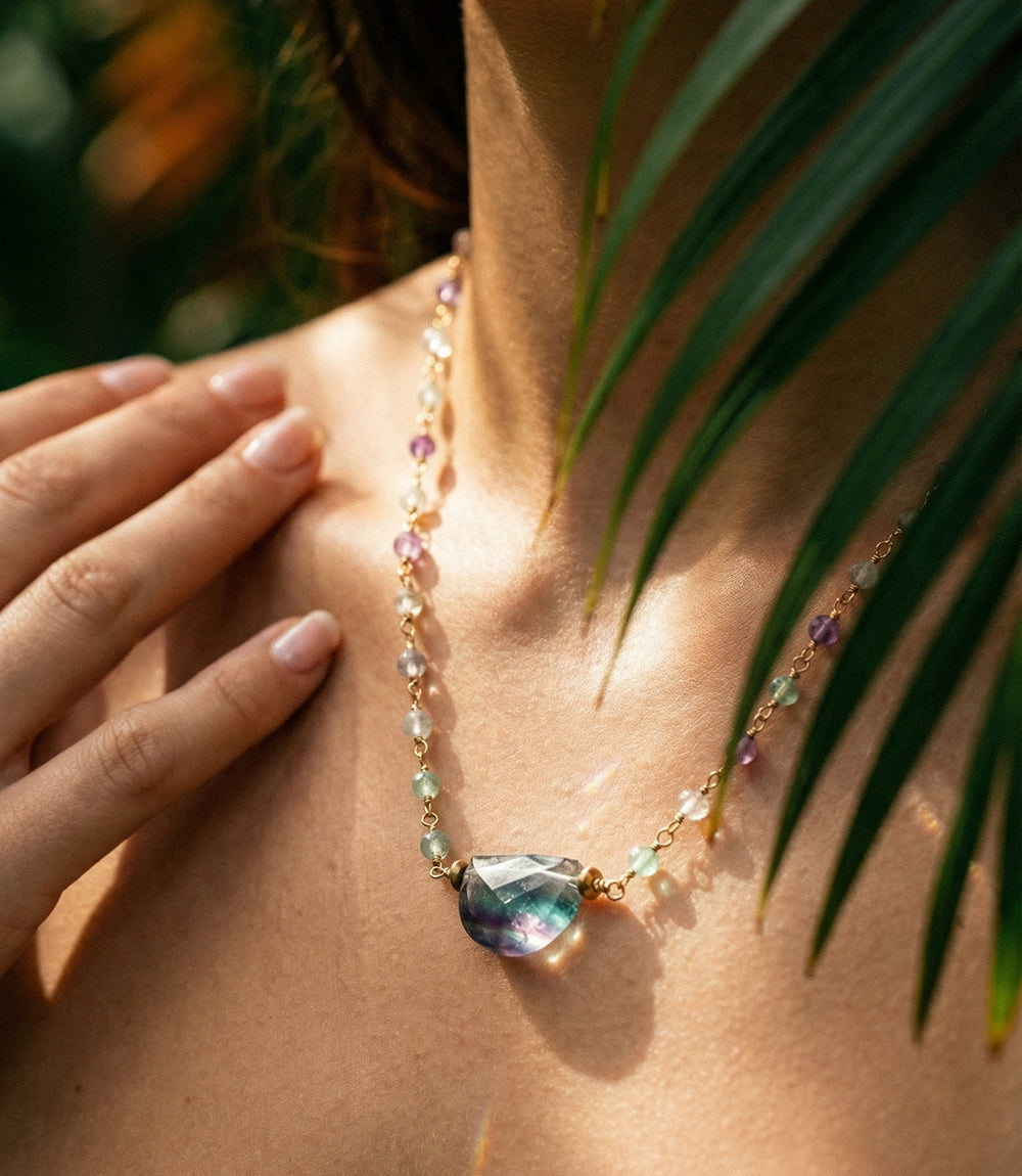 Delicate half-circle rainbow gemstone necklace with multicolored beads and gold clasp