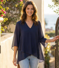 Bracelet Sleeve Asymmetric Top in silky crepe with V-neck, flare sleeves, and layered asymmetrical hem