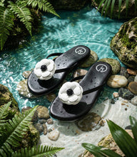 Solei Sea Valentina black thong sandals with white flower appliqué and contoured footbed