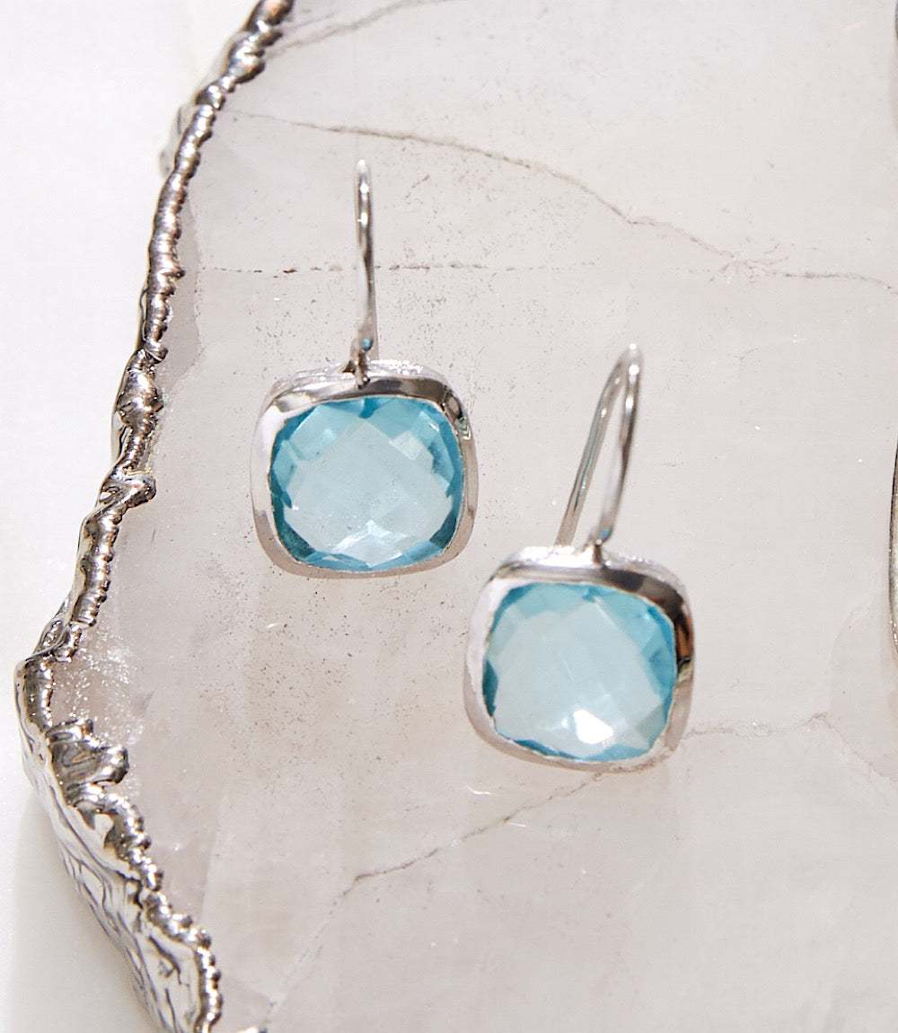 Elegant blue topaz drop earrings with cushion cut stones set in rhodium-plated brass
