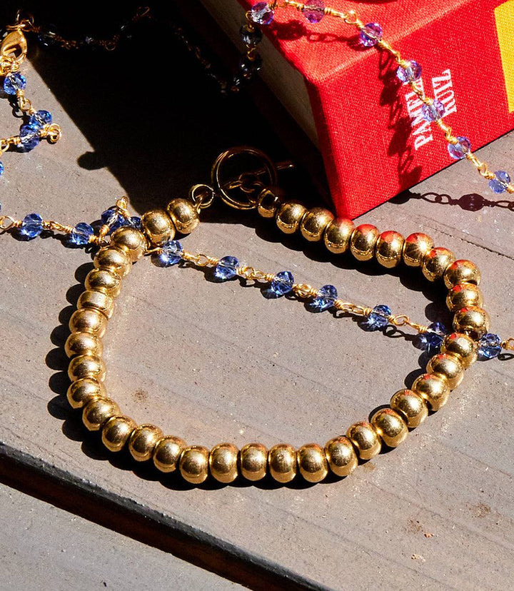 Brass beaded bracelet with gold toggle clasp showcasing warm golden tones and modern elegance