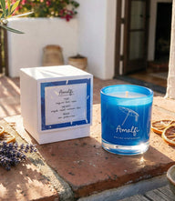 Blue glass Amalfi candle with citrus, herbal, and floral fragrance in stylish packaging
