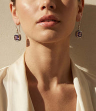 Embellished sterling silver gemstone earrings with amethyst stones and detailed silver frame