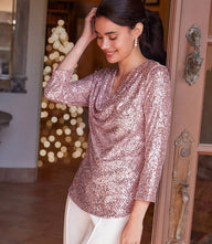 woman wearing 3/4 sleeve drape front sequin top in pink shimmer