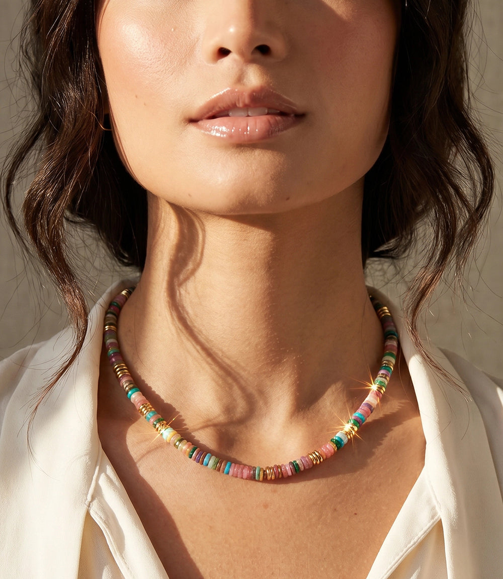 Colorful beaded shell necklace with gold accents and lobster clasp closure