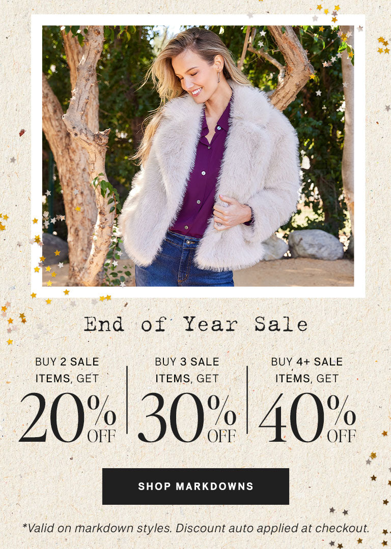Woman wearing a fur coat with a scenic background, promoting an end-of-year sale.