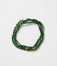 Emerald green crystal beaded stretch bracelet with gold accents