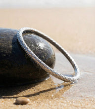 Sterling silver bangle bracelet with subtle texture and push clasp closure for modern, comfortable wear