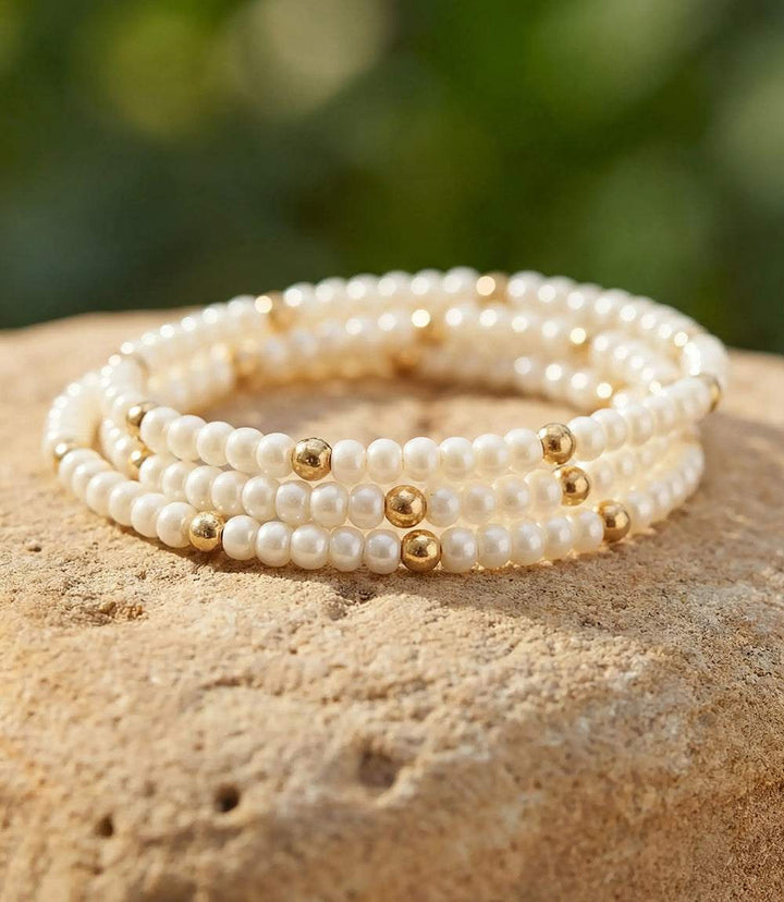 Set of 3 beaded crystal bracelets with pearl-white Czech glass and gold accents, stretch design for stacking