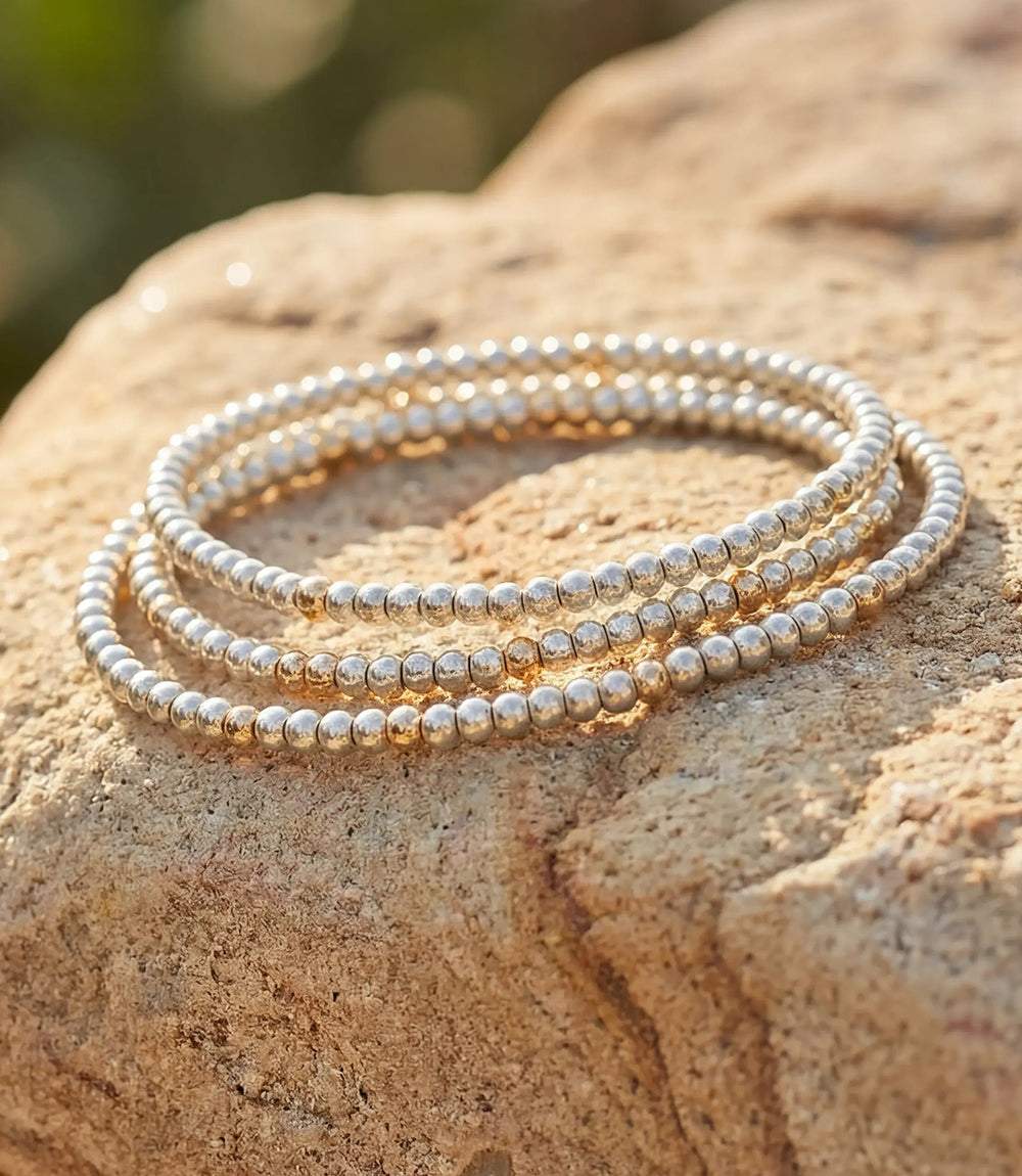 Set of 3 beaded crystal bracelets with platinum-toned glass and gold-filled beads, elegant and versatile slip-on design