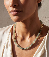 Beaded Necklace with faceted rectangular and square green beads accented by polished gold-tone clasp and extender chain