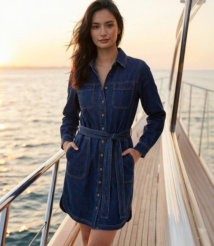 Belted denim shirtdress with mandarin collar, button-front, chest and side pockets, and removable self-tie belt for a flattering waist.