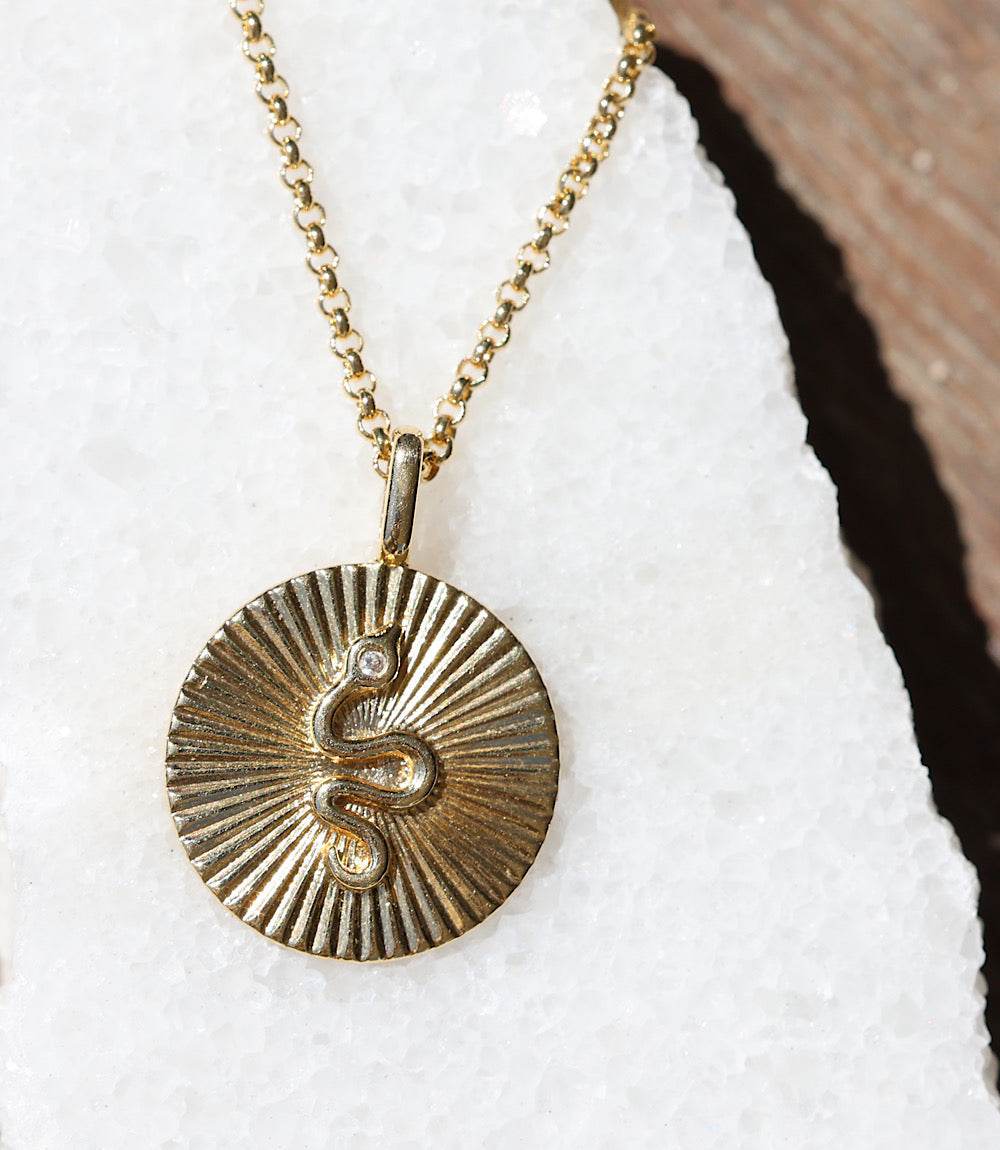 Gold 18K Radial Serpent Pendant Necklace with coiled serpent design on textured radiating background