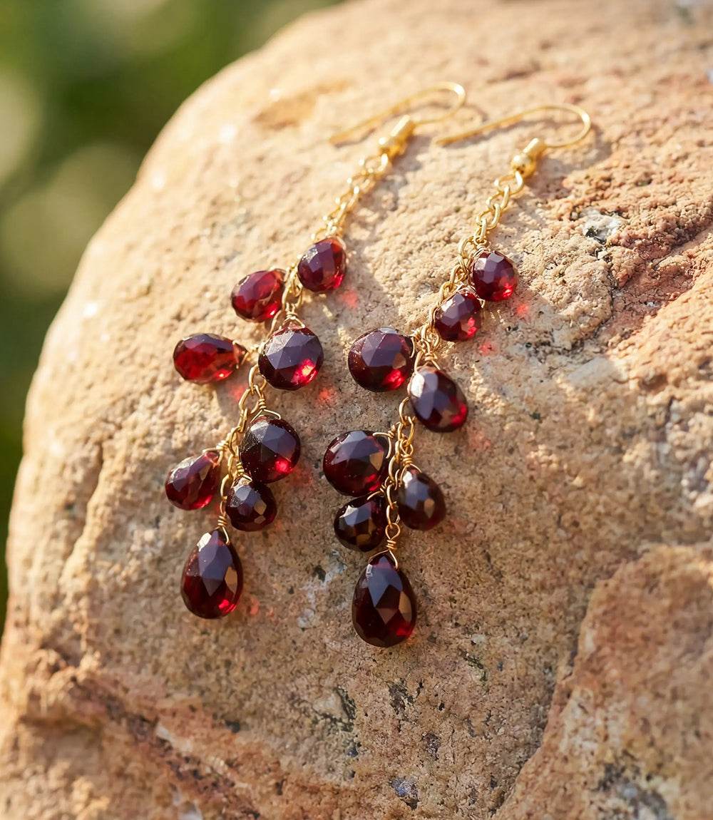 Cascading gemstone earrings with burgundy synthetic garnets on gold-plated chains and gold hooks