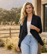 Woman wearing a Drape Travel Jersey long sleeve open-front cardigan with a soft drape and relaxed fit