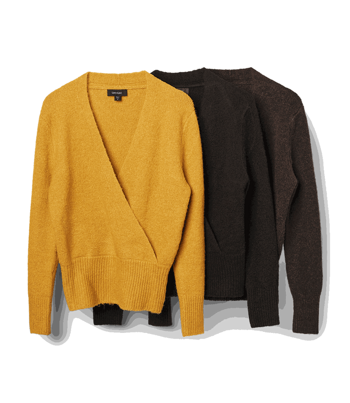 Three wrap sweaters in mustard yellow, black, and brown with faux wrap design, crossover V-neckline, long drop shoulder sleeves, and wide ribbed edges at hem and cuffs.
