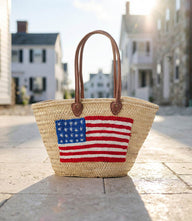 Embroidered Straw Tote Bag with US flag design and brown handles made of natural straw