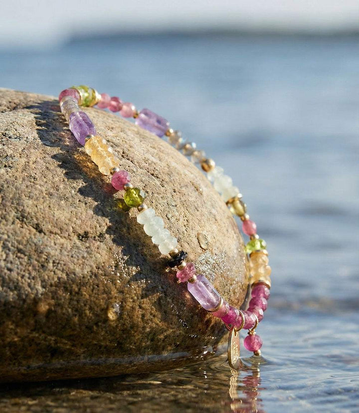 Multicolored gemstone collage bracelet with gold accents and lobster clasp