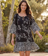 Black Contrast Ruffle Hem Dress with off white floral print, tie neck, and three-quarter flare sleeves