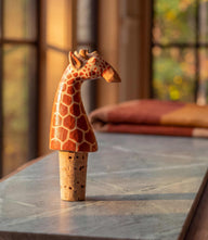Wooden giraffe bottle stopper with natural cork base for beverage sealing and decoration