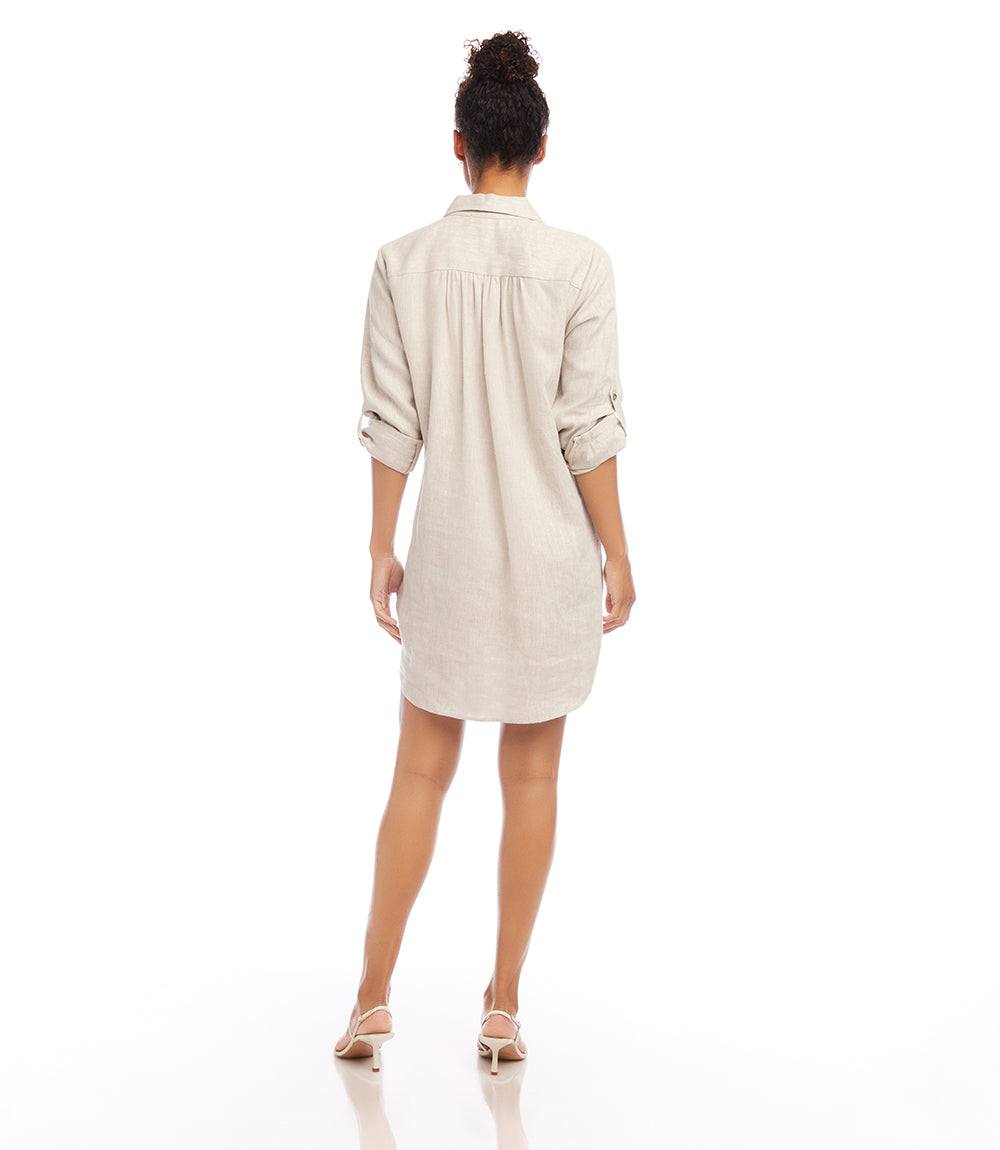 Petite size roll tab linen shirtdress in oatmeal with collared neckline, front pocket, and shirttail hem, shown from back.