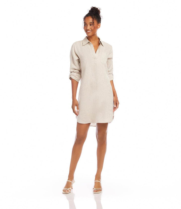 Woman wearing oatmeal roll tab linen shirtdress with collared neckline and shirttail hem