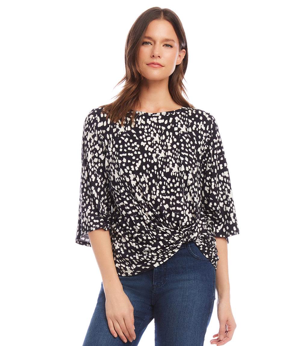 Petite size flare sleeve top with modern dot print and twist hem, made from soft Italian fabric.