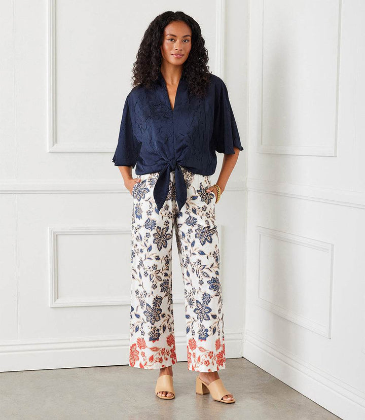 Woman wearing lightweight cotton drawstring cropped pants with batik border print and wide-leg design