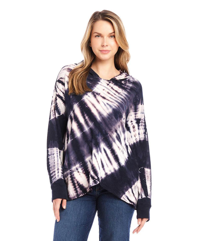 Woman wearing a relaxed fit tie dye asymmetric hem hoodie with crew neck and drop shoulder sleeves