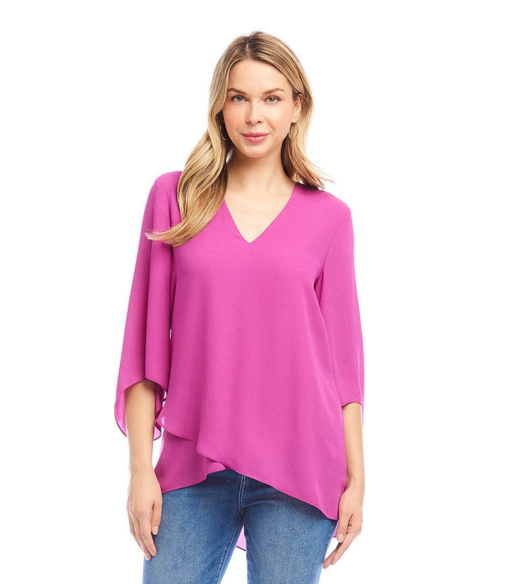 Woman wearing pink Bracelet Sleeve Asymmetric Top with V-neck and layered asymmetrical hem paired with blue jeans