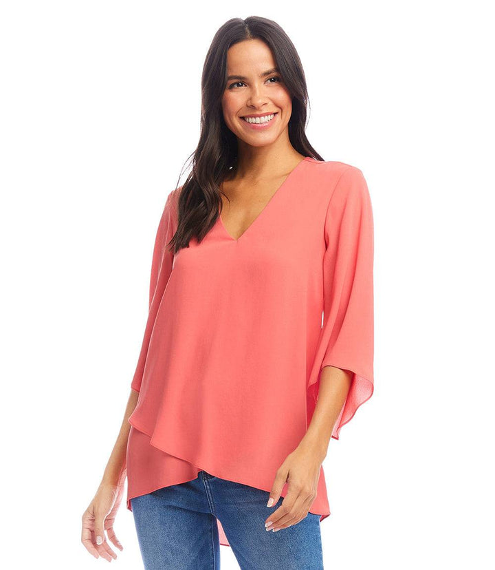 Woman wearing coral Bracelet Sleeve Asymmetric Top with V-neck and layered hem