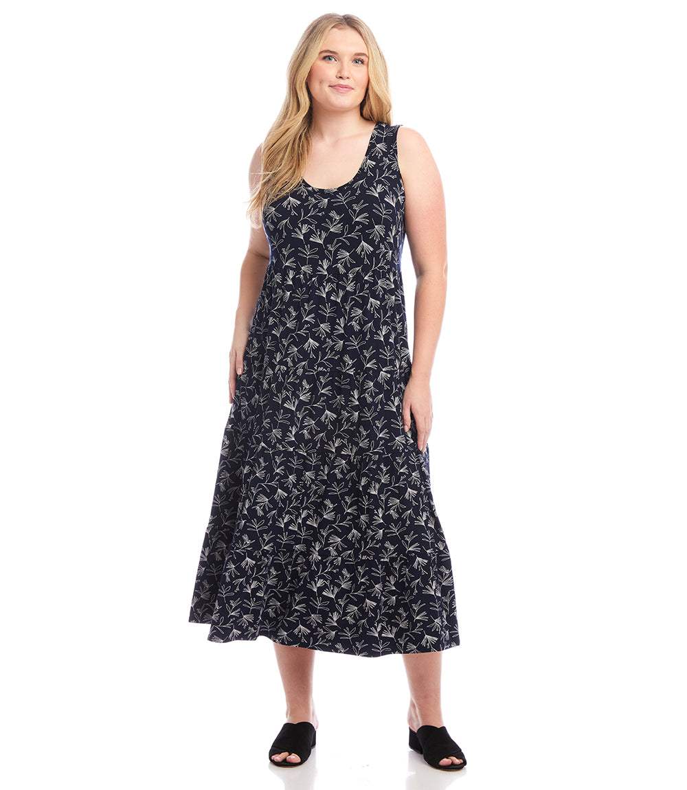 Plus size sleeveless tiered midi dress with white floral print on navy background and scoop neck