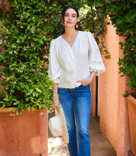 Embroidered button-front top with V-neck, delicate embroidery, pintuck accents, and gathered sleeves in soft cotton poplin.