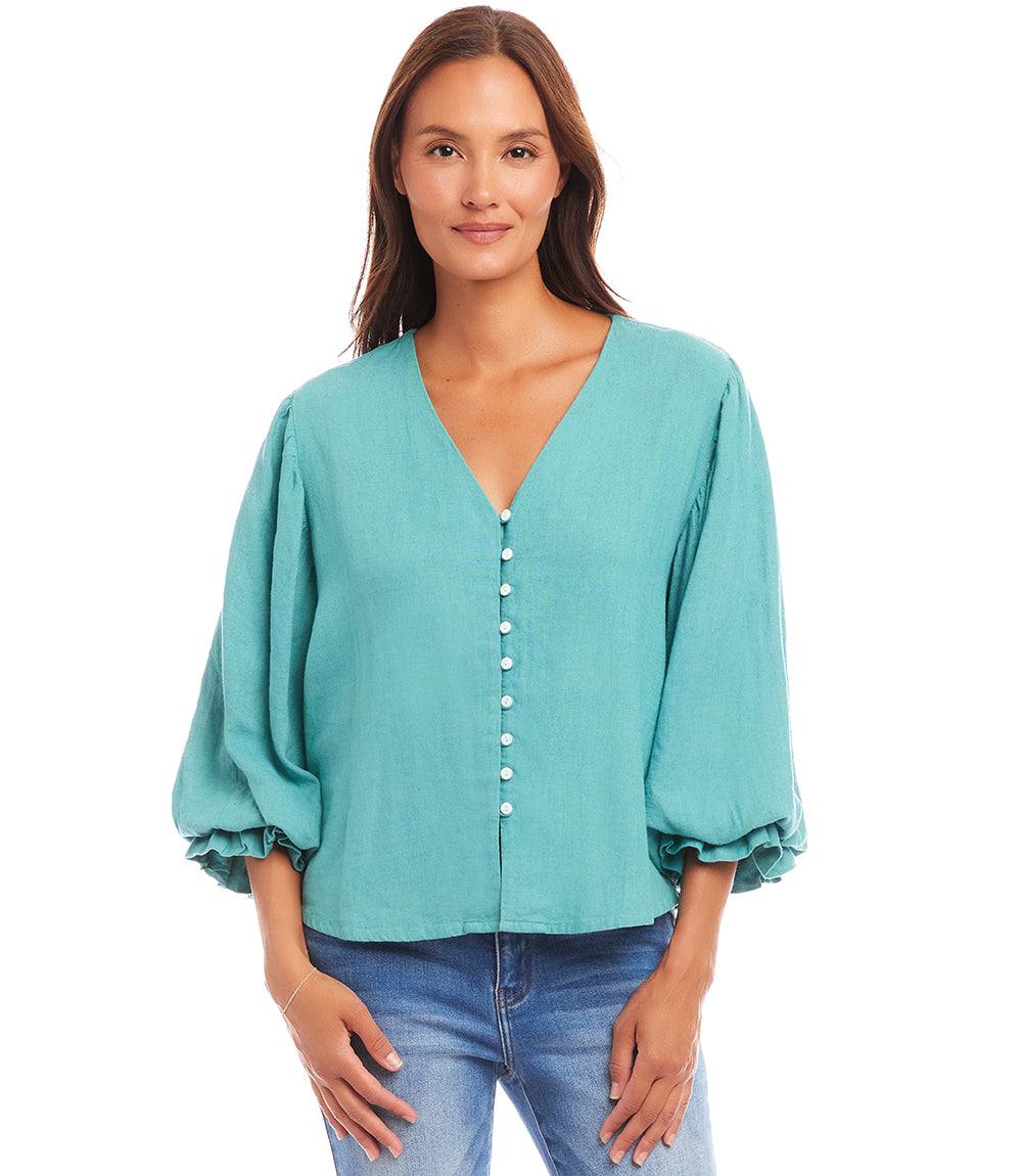 woman wearing turquoise layered sleeve shirred blouse with V-neck and button front closure
