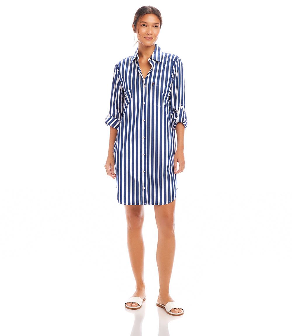 Woman wearing a relaxed-fit Roll Tab Stripe Shirtdress with bold white and navy stripes and roll-up sleeves
