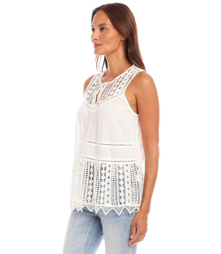 Woman wearing white lace trim sleeveless top with front keyhole and relaxed fit pairing with light blue jeans