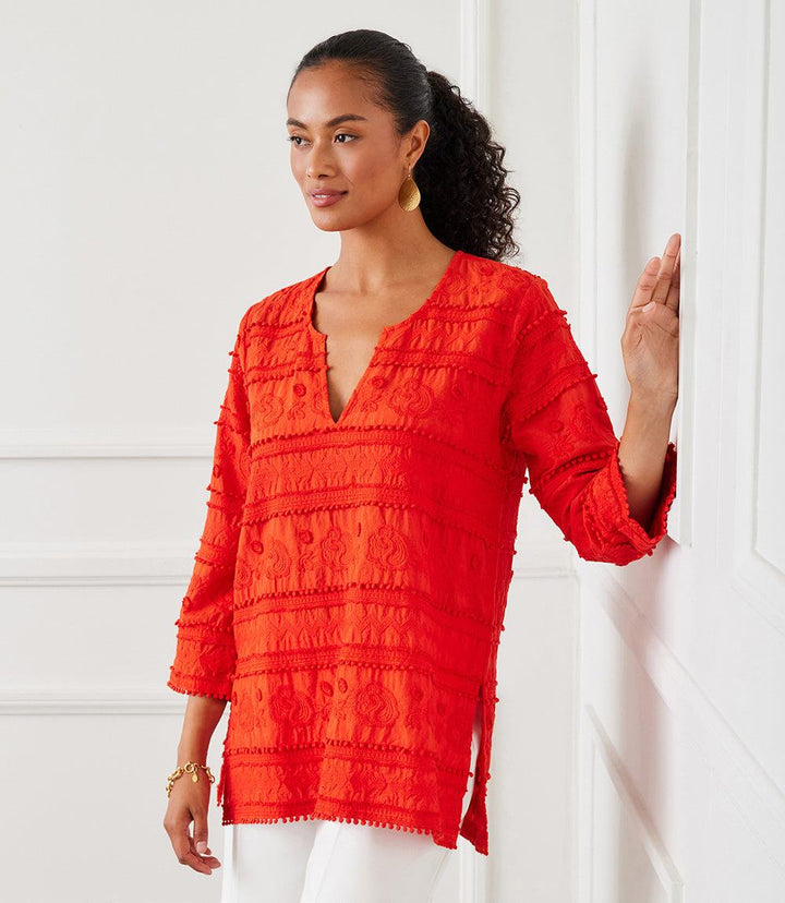 Woman wearing a vibrant red 3/4 sleeve embroidered cotton tunic with split neck and side slits