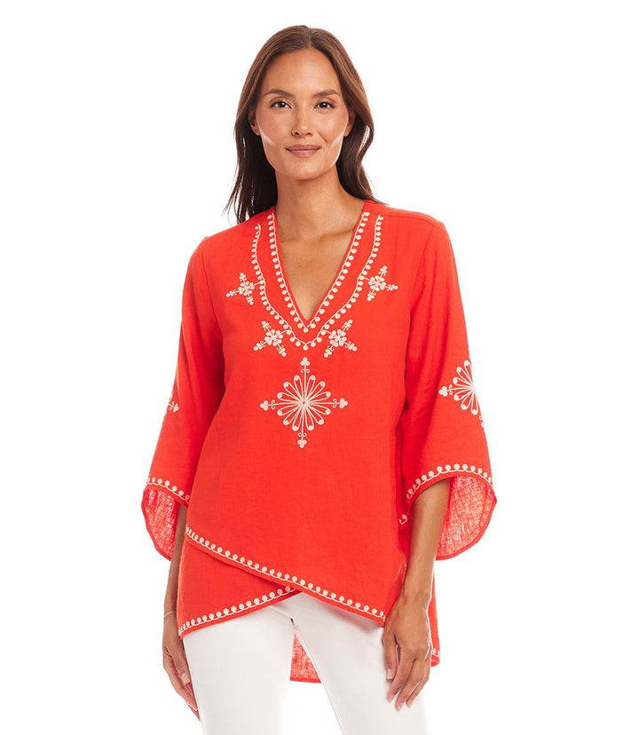 Woman wearing red bracelet sleeve asymmetric top with embroidery and layered hem
