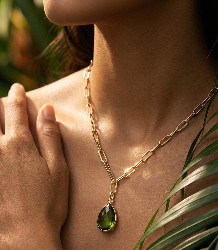 Peridot gemstone teardrop necklace with gold plating and vibrant green pendant on delicate chain