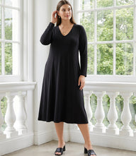 Plus size woman wearing Kate V-neck midi travel dress with long sleeves and subtle flare skirt