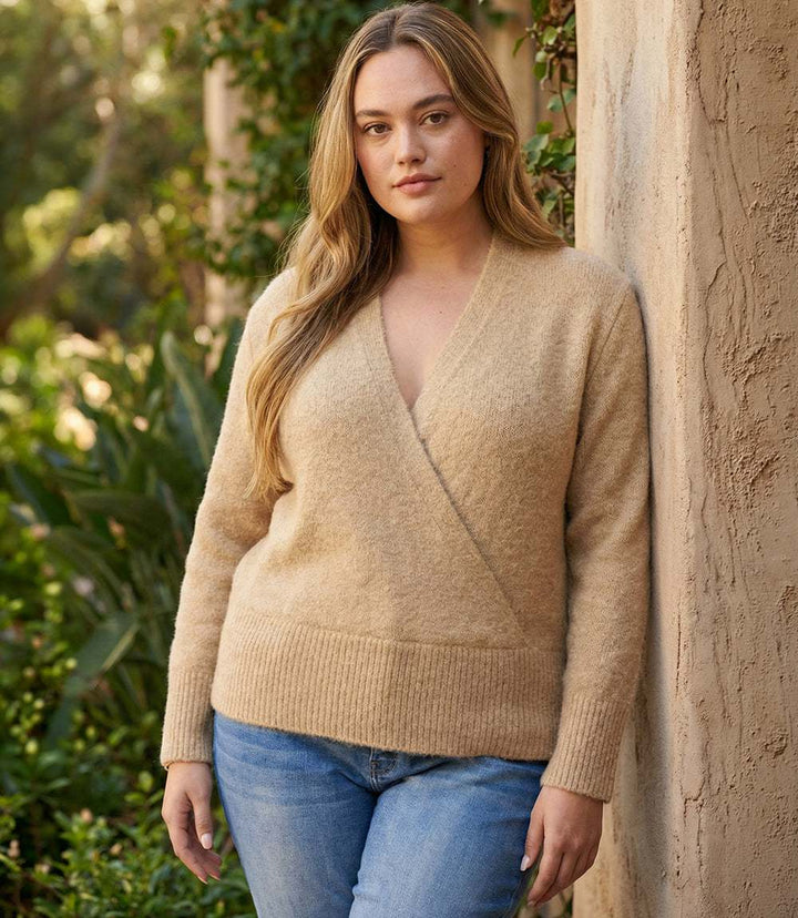 Plus size wrap sweater with deep V-neck and ribbed hem in plush knit fabric