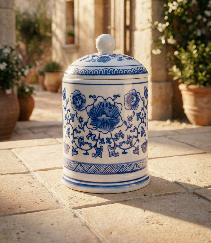 Elegant porcelain candle with blue floral design in white ceramic jar