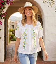 Yellow puff sleeve embroidered peasant top with floral embroidery and button-front design