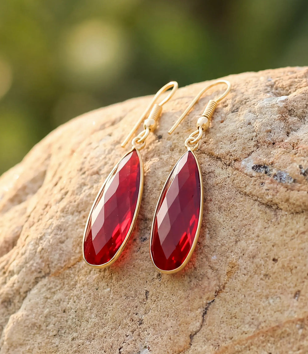 Ruby quartz earrings with faceted teardrop stones in gold-plated brass, lightweight and elegant design