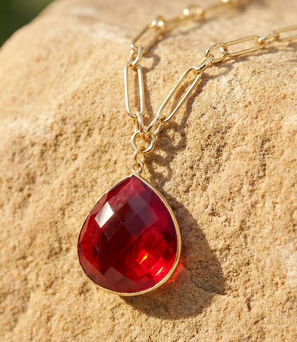 Ruby quartz pendant necklace with faceted gemstone on gold plated paperclip chain