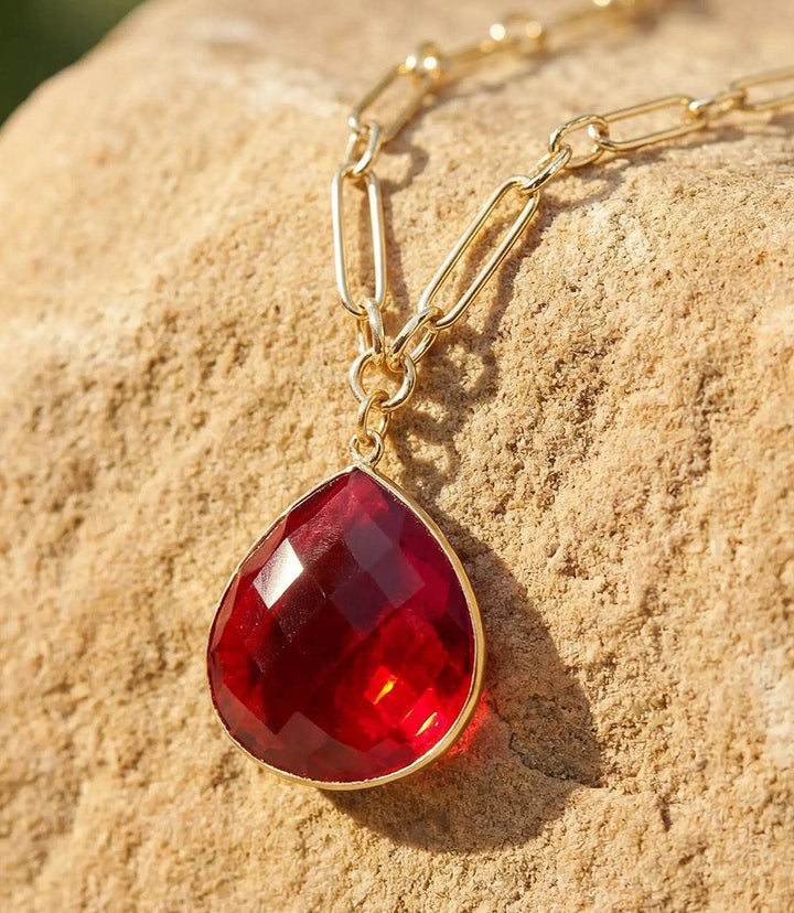Ruby quartz pendant necklace with faceted gemstone on gold plated paperclip chain