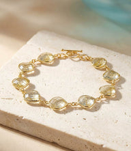 Gold Rutilated Quartz Bracelet with faceted stones and toggle closure